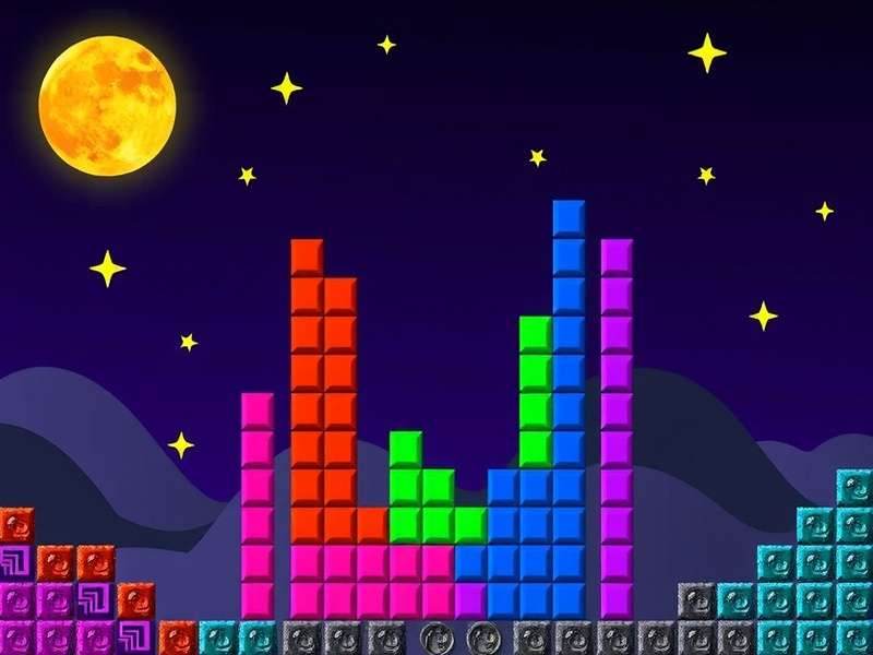 A close-up of a Game Boy playing Tetris with headphones plugged in